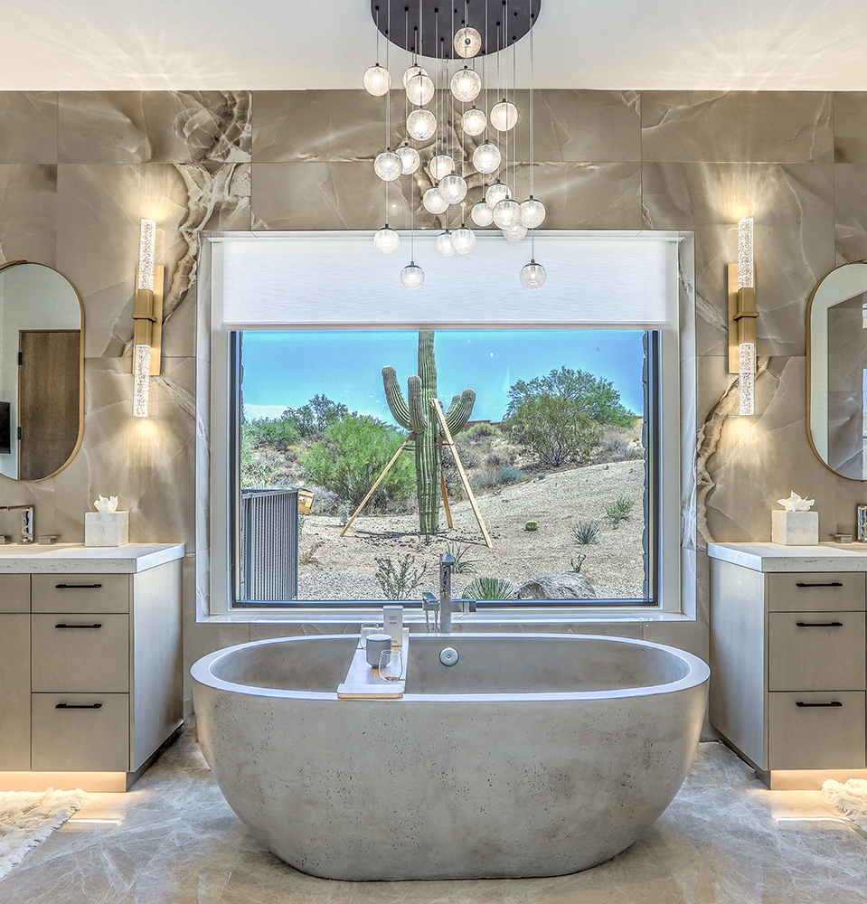 Contemporary kitchen with pale custom cabinetry and a waterfall stone island