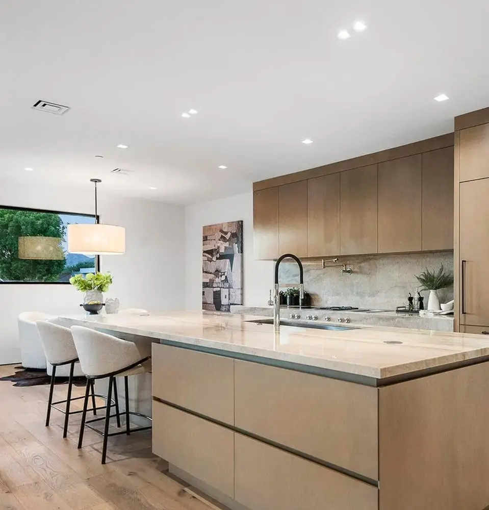 Large-format porcelain countertop and full-height splash in a modern kitchen